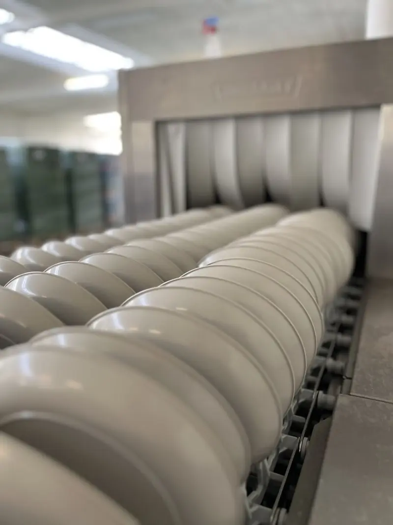 Herbruikbare bowls op de wasband in de SwapBox wasstraat